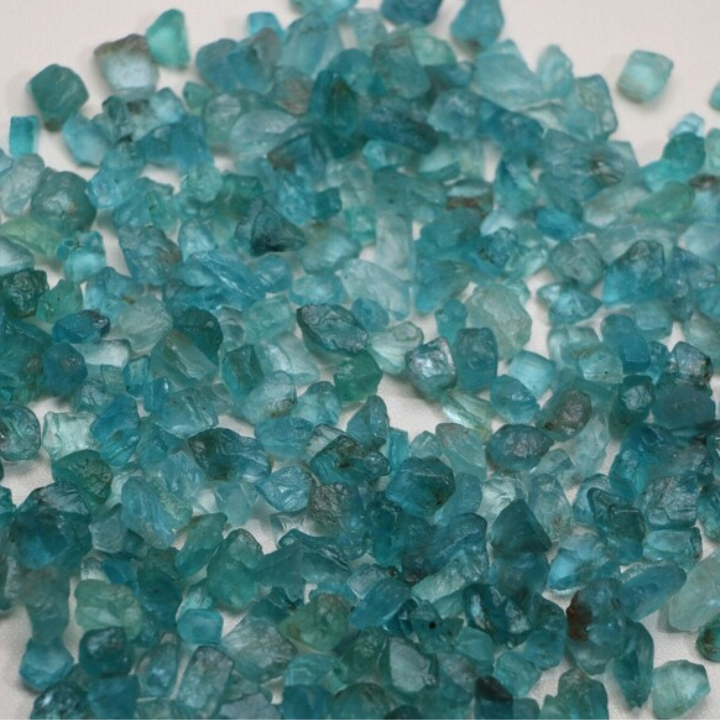Close-up of blue apatite loose gemstones on a white background
