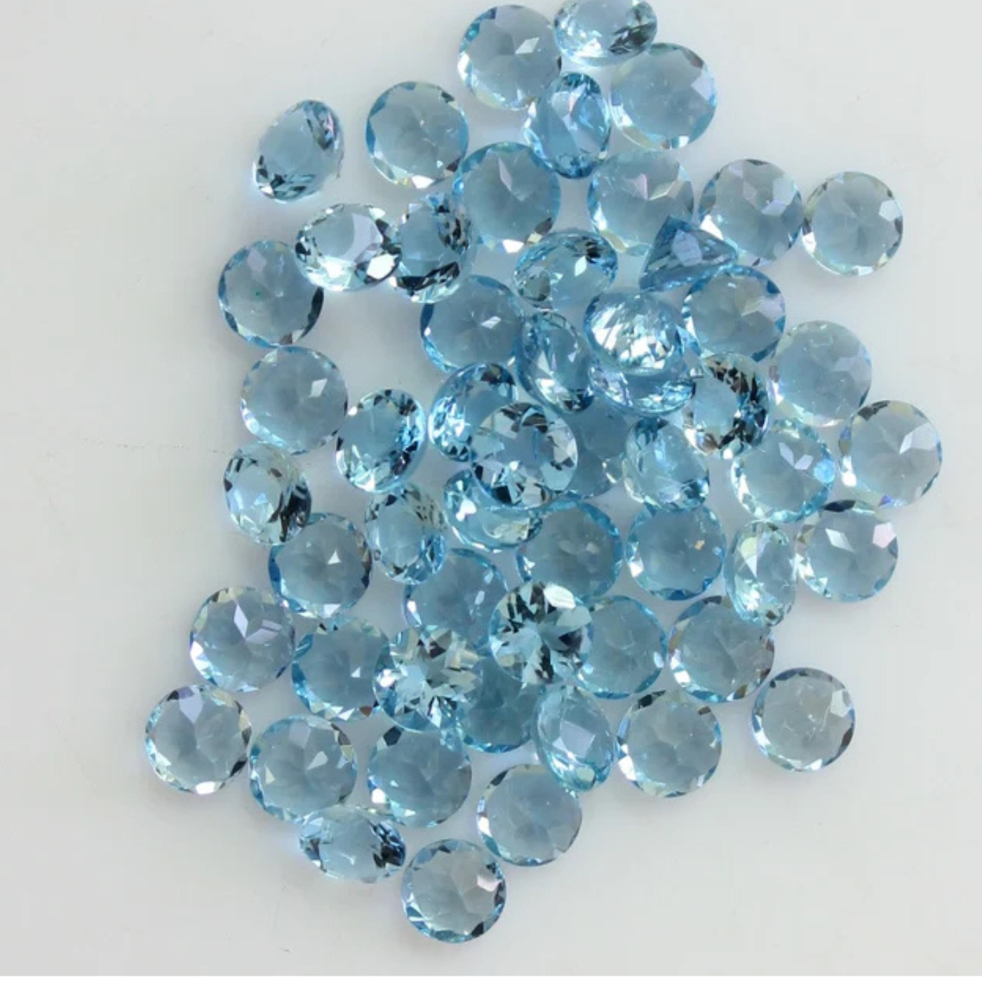 Collection of blue aquamarine gemstones on a white background