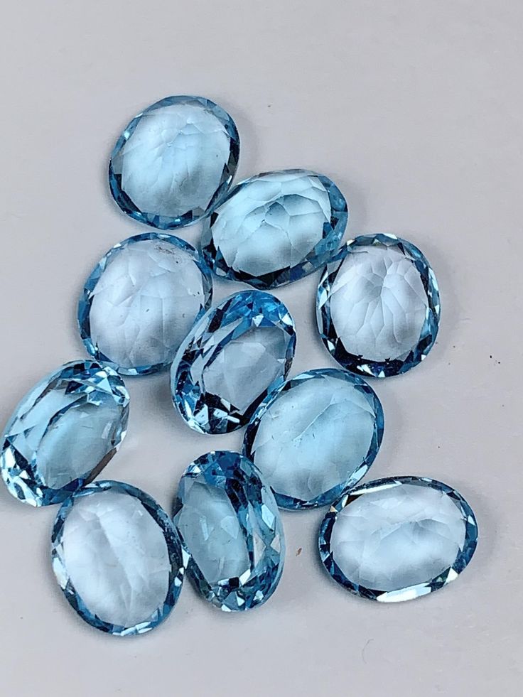 Blue topaz gemstones on a light gray background