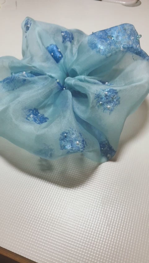 rotation video of a blue organza scrunchy
